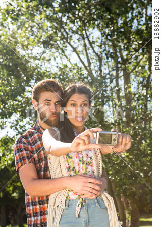 Hipster couple taking a selfie Hipster couple taking a selfie 13882902