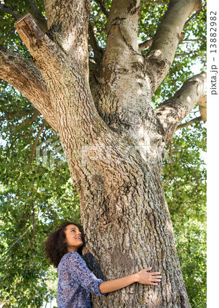 Pretty young woman hugging a tree Pretty young woman hugging a tree 13882982
