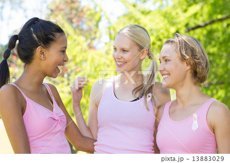 Smiling women in pink for breast cancer awareness Smiling women in pink for breast cancer awareness 13883029