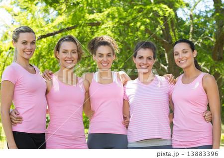 Smiling women in pink for breast cancer awareness 13883396