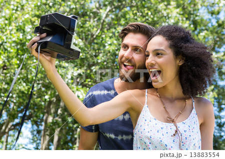 Hipster couple taking a selfie 13883554