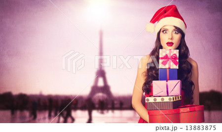 Beautiful brunette girl in christmas hat with gifts Beautiful brunette girl in christmas hat with gifts 13883875
