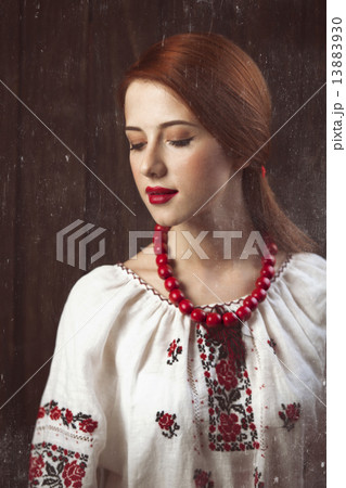 Redhead girl in ukrainian national clothing. 13883930