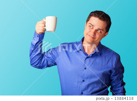 Casual man in shirt with cup on blue background. Casual man in shirt with cup on blue background. 13884118