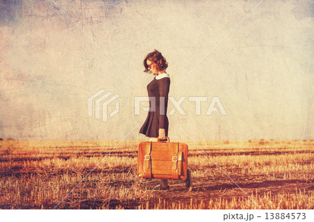 Beautiful brunette girl with suitcase on the field Beautiful brunette girl with suitcase on the field 13884573