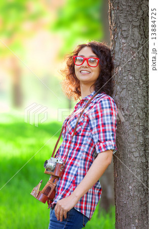 Indian girl with camera in the park. Indian girl with camera in the park. 13884725