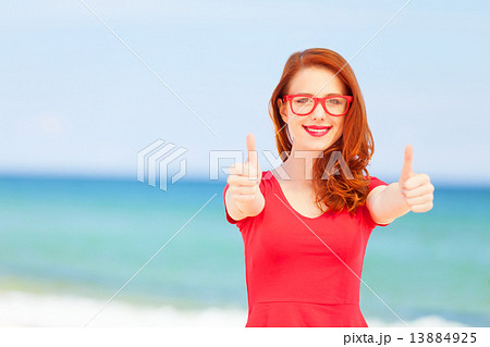 Redhead girl in the glasses on the beach Redhead girl in the glasses on the beach 13884925