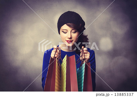 women in blue dress with shopping bags 13885337