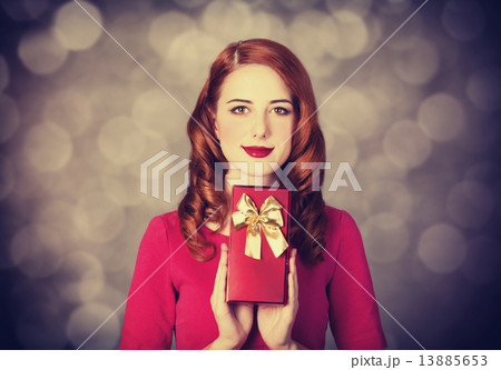 Redhead women with gift. 13885653