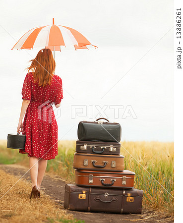 Redhead girl with suitcases at outdoor Redhead girl with suitcases at outdoor 13886261