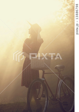 Girl on a bike in the countryside in sunrise time 13886798