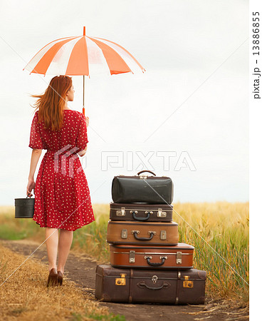 Redhead girl with suitcases at outdoor 13886855