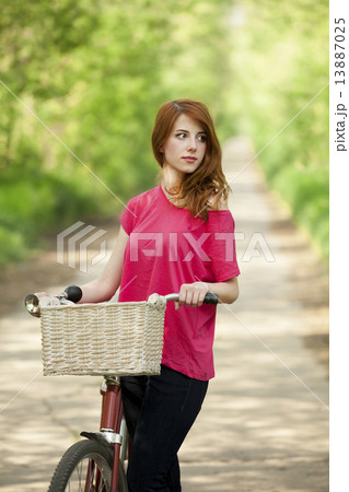 Girl with a bike in the countryside Girl with a bike in the countryside 13887025