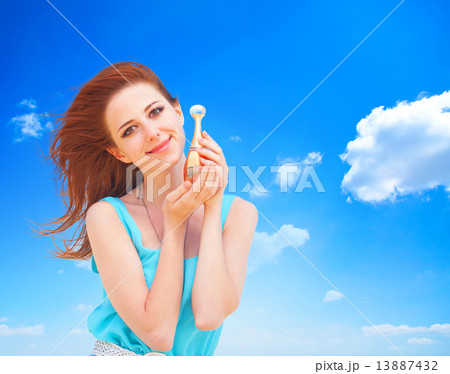 Redhead women with perfume at blue sky background. Redhead women with perfume at blue sky background. 13887432