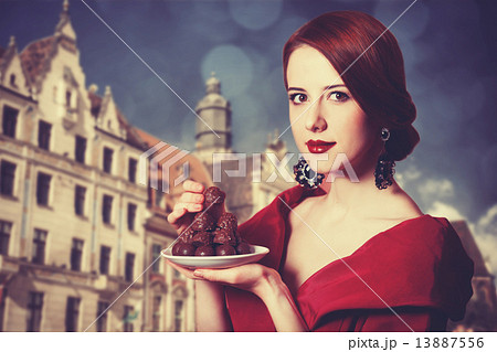 Beautiful redhead women with candy. 13887556