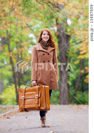 Redhead girl with suitcase at autumn outdoor Redhead girl with suitcase at autumn outdoor 13887609