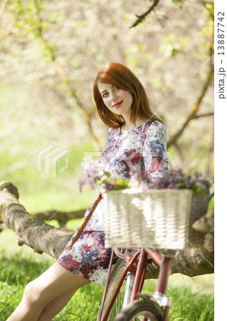 Girl on a bike in the countryside Girl on a bike in the countryside 13887742