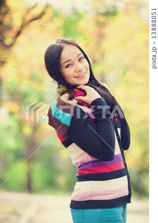 Brunette girl at autumn alley in the park Brunette girl at autumn alley in the park 13888051