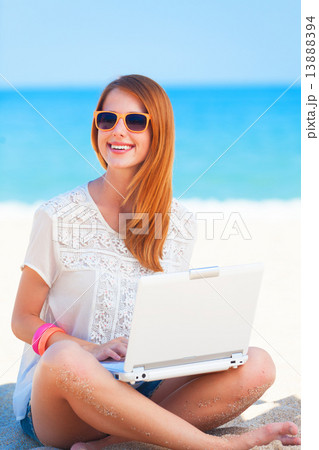 Cute woman with white laptop on the summer beach Cute woman with white laptop on the summer beach 13888394