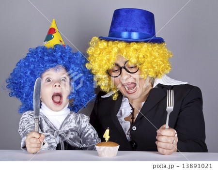 Mother and child in funny wigs and cake at birthday. Studio shot 13891021