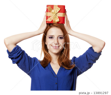 Beautiful red-haired girl with present box. 13891297