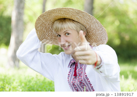 Young slav teen at green meadow in national clothing. 13891917