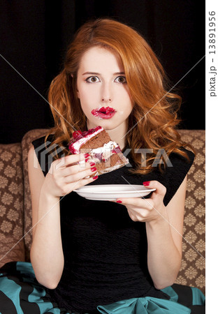 Redhead girl eating cake Redhead girl eating cake 13891956