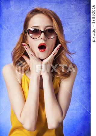 American redhead girl in sunglasses. Photo in 60s style. American redhead girl in sunglasses. Photo in 60s style. 13892016