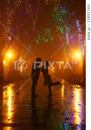 Couple walking at alley in night lights. Photo in vintage style. 13892164