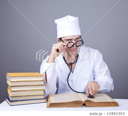 Young male doctor studying medical books Young male doctor studying medical books 13892303