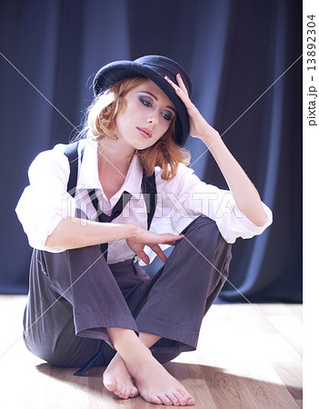 Fashion redhead girl with tie in studio. Fashion redhead girl with tie in studio. 13892304