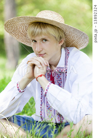 Young slav teen at green meadow in national clothing. 13892324