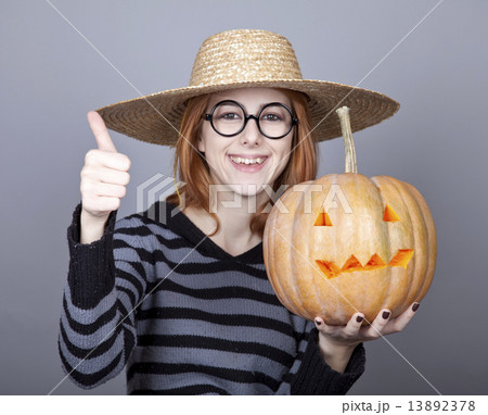 Funny girl in cap showing pumpkin. Funny girl in cap showing pumpkin. 13892378
