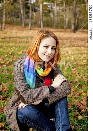 Portrait of red-haired girl in the autumn park. 13892706