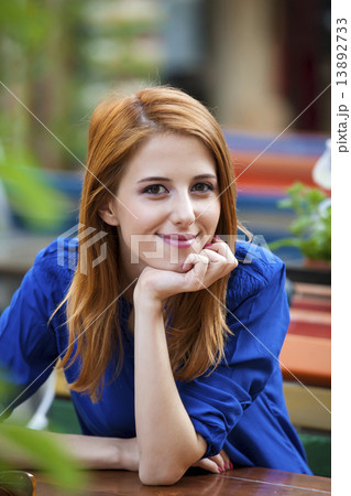 Style redhead girl sittin on the bench in the cafe Style redhead girl sittin on the bench in the cafe 13892733