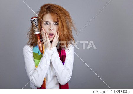 Sad red-haired girl with comb. 13892889