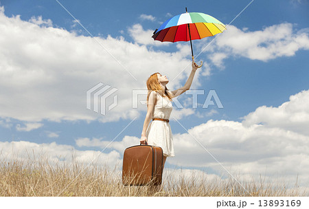 Beautiful redhead girl with umbrella and suitcase at outdoor. Beautiful redhead girl with umbrella and suitcase at outdoor. 13893169