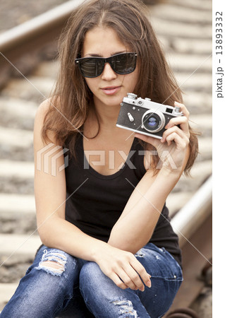 Teen girl with camera at railways. Teen girl with camera at railways. 13893332