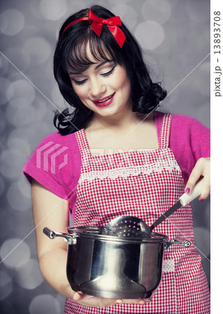Brunette housewife with soup ladle 13893708
