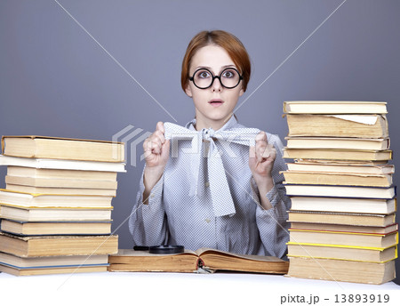 The young teacher in glasses with books. 13893919