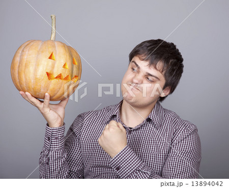 Funny men showing a pumpkin. 13894042