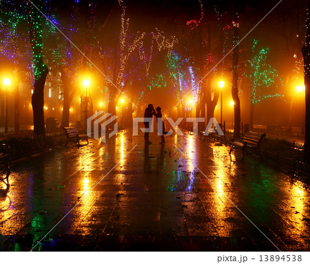 Couple walking at alley in night lights. Photo in vintage style. Couple walking at alley in night lights. Photo in vintage style. 13894538