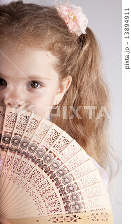 Portrait of beautiful young girl with fan 13894911