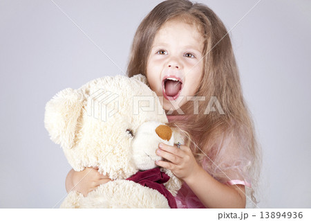 Little shouting girl embraces bear cub. Little shouting girl embraces bear cub. 13894936