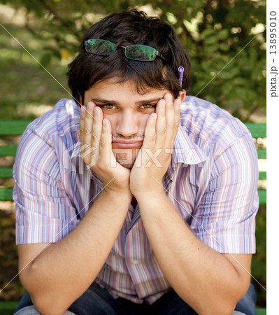 Men with glasses doing homework at the park. Men with glasses doing homework at the park. 13895010