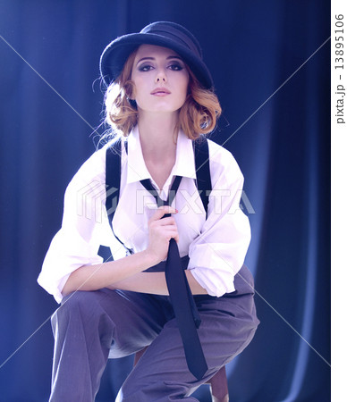 Fashion redhead girl with tie in studio. Fashion redhead girl with tie in studio. 13895106