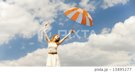 Girl with umbrella at sky background. 13895277
