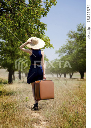 Lonely girl with suitcase at countryside. 13895374