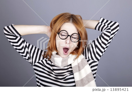 Sleeping red-haired girl in glasses and scarf. Sleeping red-haired girl in glasses and scarf. 13895421