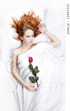 Fashion red-haired girl with rose in the bedroom. 13895545